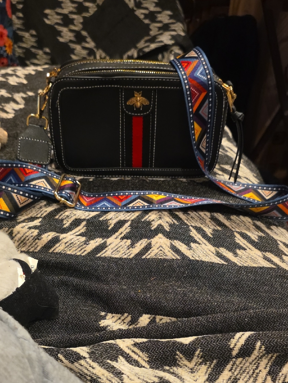 Black Crossbody Camera Bag with Red Stripe and Embossed Bee